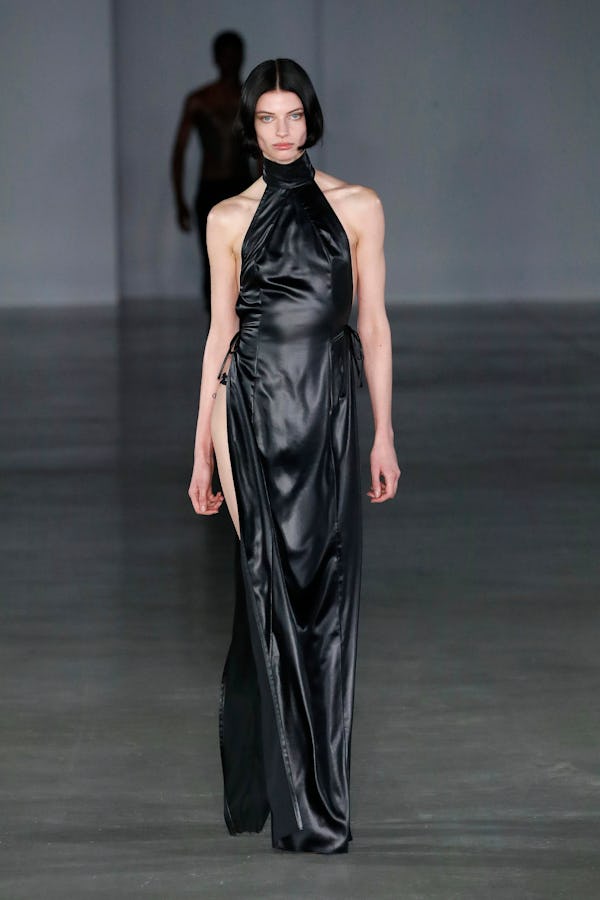 a model wearing a leather halter maxi dress with a slit on the Ludovic De Saint-Sernin runway