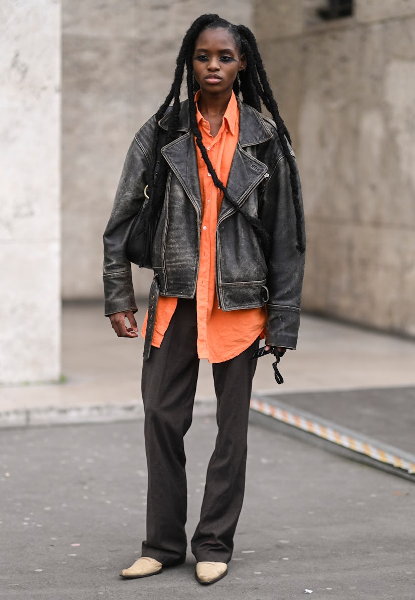PARIS, FRANCE - MARCH 02: A model is seen wearing a vintage jacket, orange shirt and brown pants out...