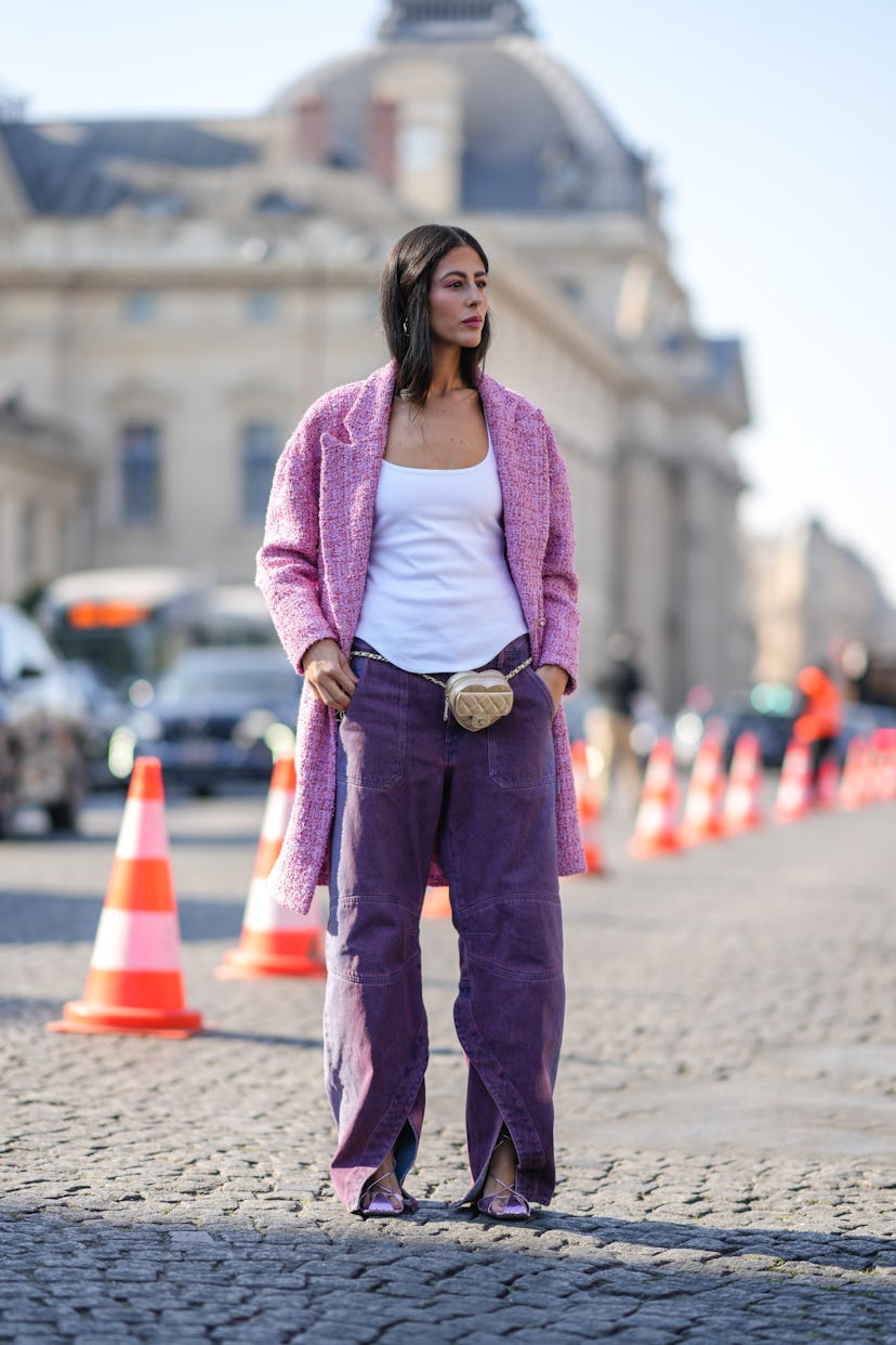 PARIS, FRANCE - MARCH 08: Gilda Ambrosio wears a white tank-top, a pale pink tweed long jacket from ...