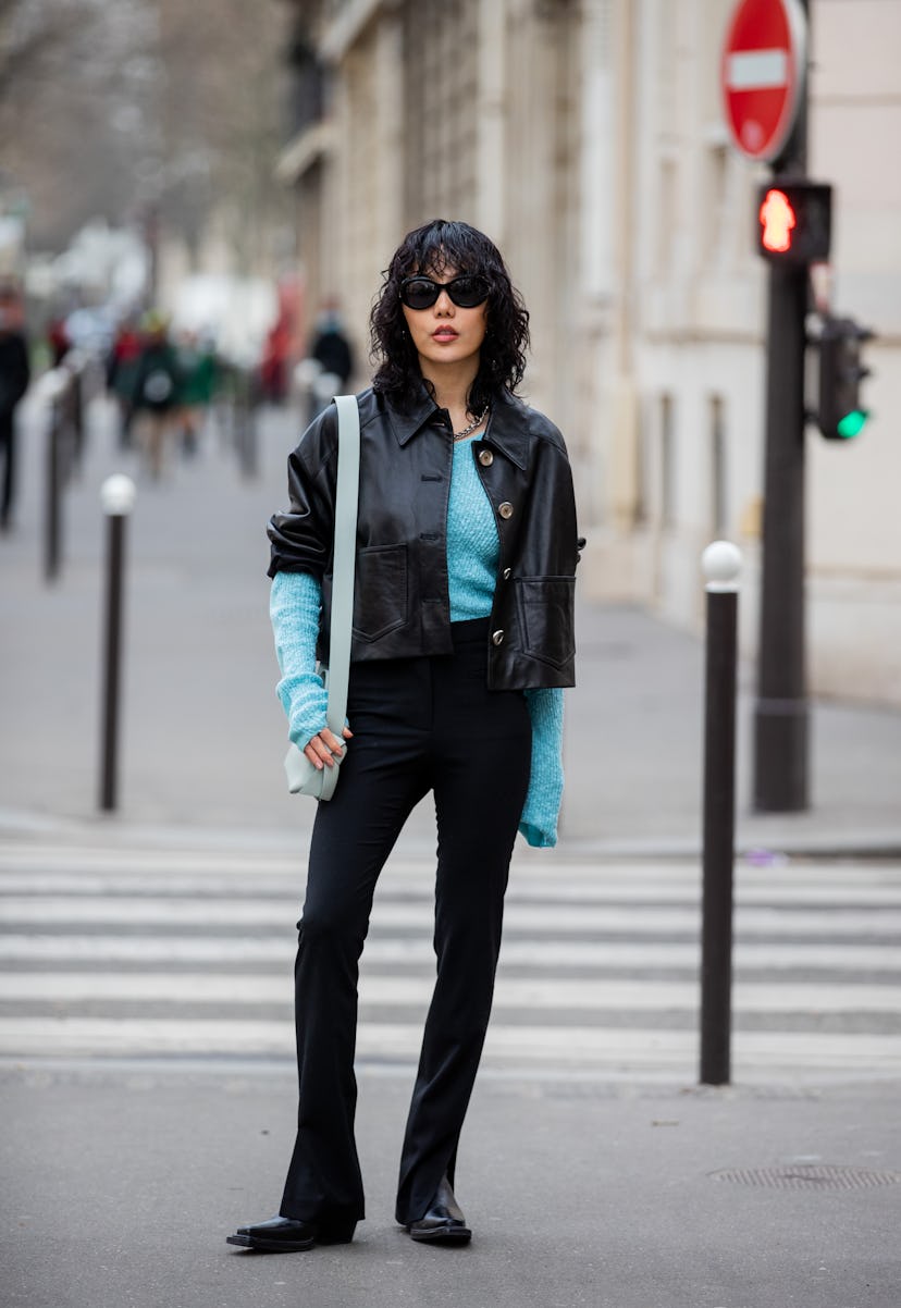 PARIS, FRANCE - MARCH 02: Xiayan Guo seen wearing black leather jacket, turquoise jumper, black pant...