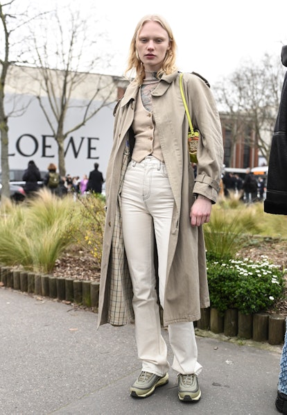 PARIS, FRANCE - MARCH 04: Model Vilma Sjoberg is seen wearing a tan coat, tan vest, white pants and ...