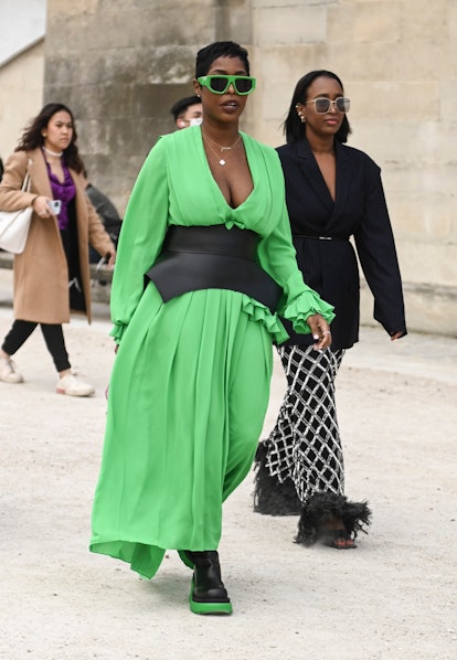 PARIS, FRANCE - MARCH 01:  A guest is seen wearing a green dress and green sunglasses outside the Di...