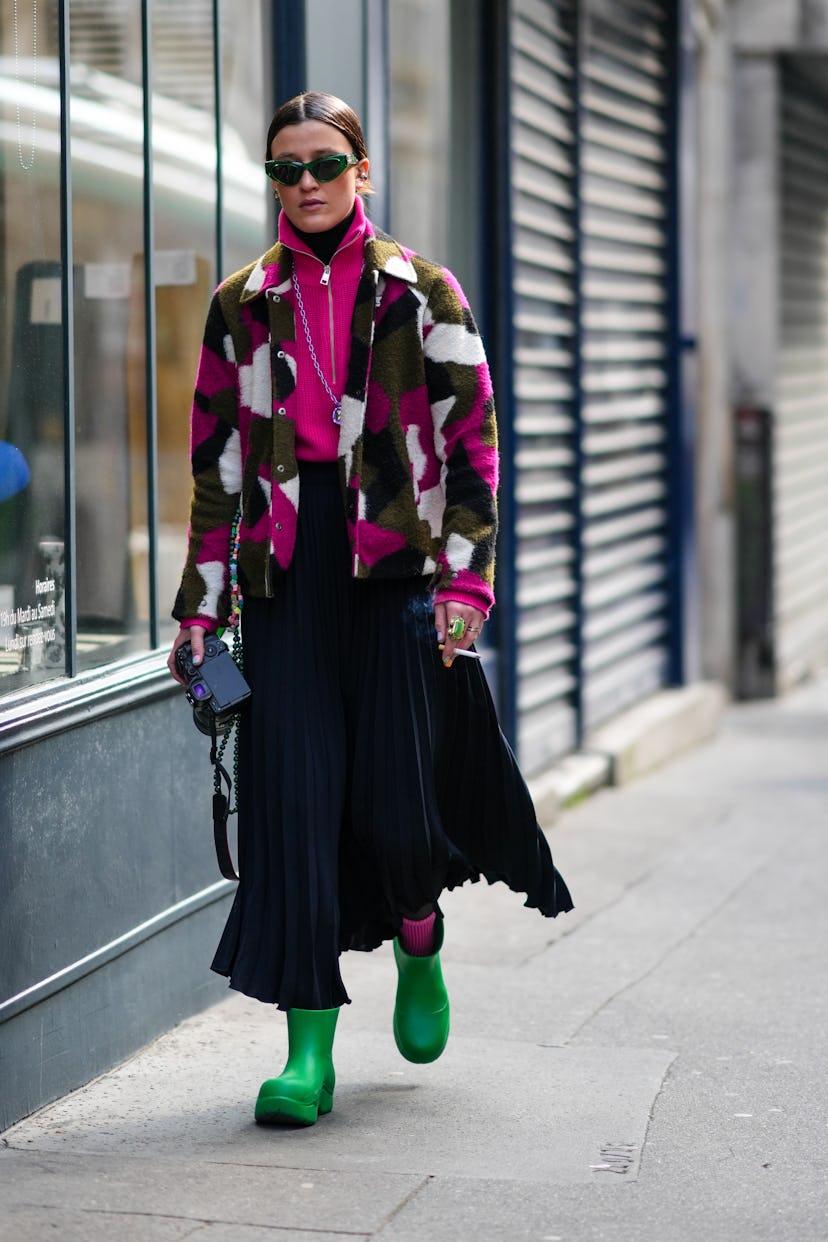 PARIS, FRANCE - MARCH 05: A guest wears green sunglasses from Chanel, a black wool turtleneck pullov...