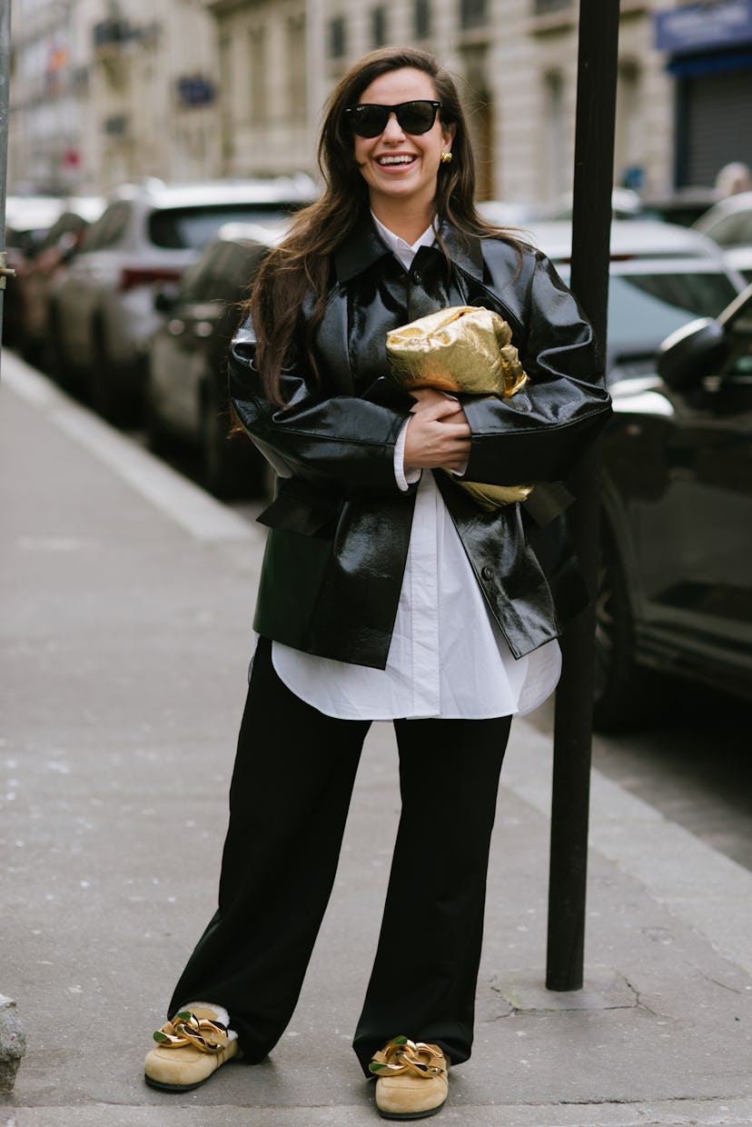 PARIS, FRANCE - MARCH 02: A guest poses wearing JW Anderson slippers before the Acne Studios show at...