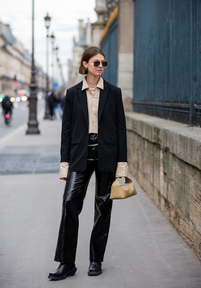 PARIS, FRANCE - MARCH 01: Jacqueline Zelwis wearing beige button shirt, black blazer, bag, vinyl pan...