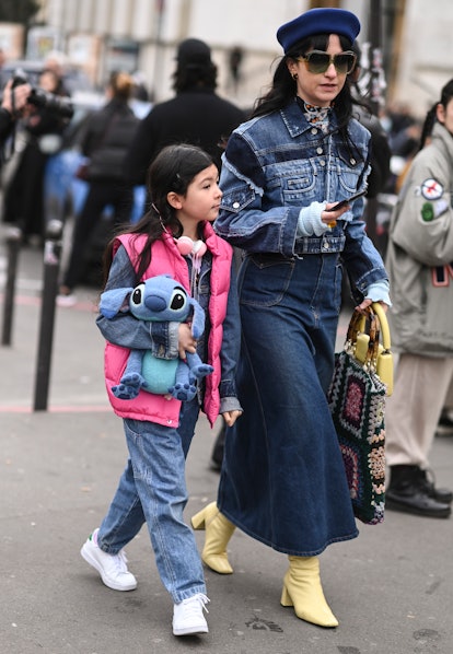 PARIS, FRANCE - MARCH 02: A guest is seen wearing a jean jacket, jean skirt and yellow boots with a ...