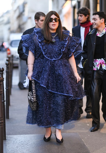 PARIS, FRANCE - FEBRUARY 28: A guest is seen wearing a blue Vaquera dress and black sunglasses outsi...