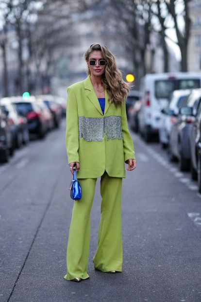 PARIS, FRANCE - MARCH 05: Maja Malnar wears black sunglasses, a royal blue electric shoulder-off top...