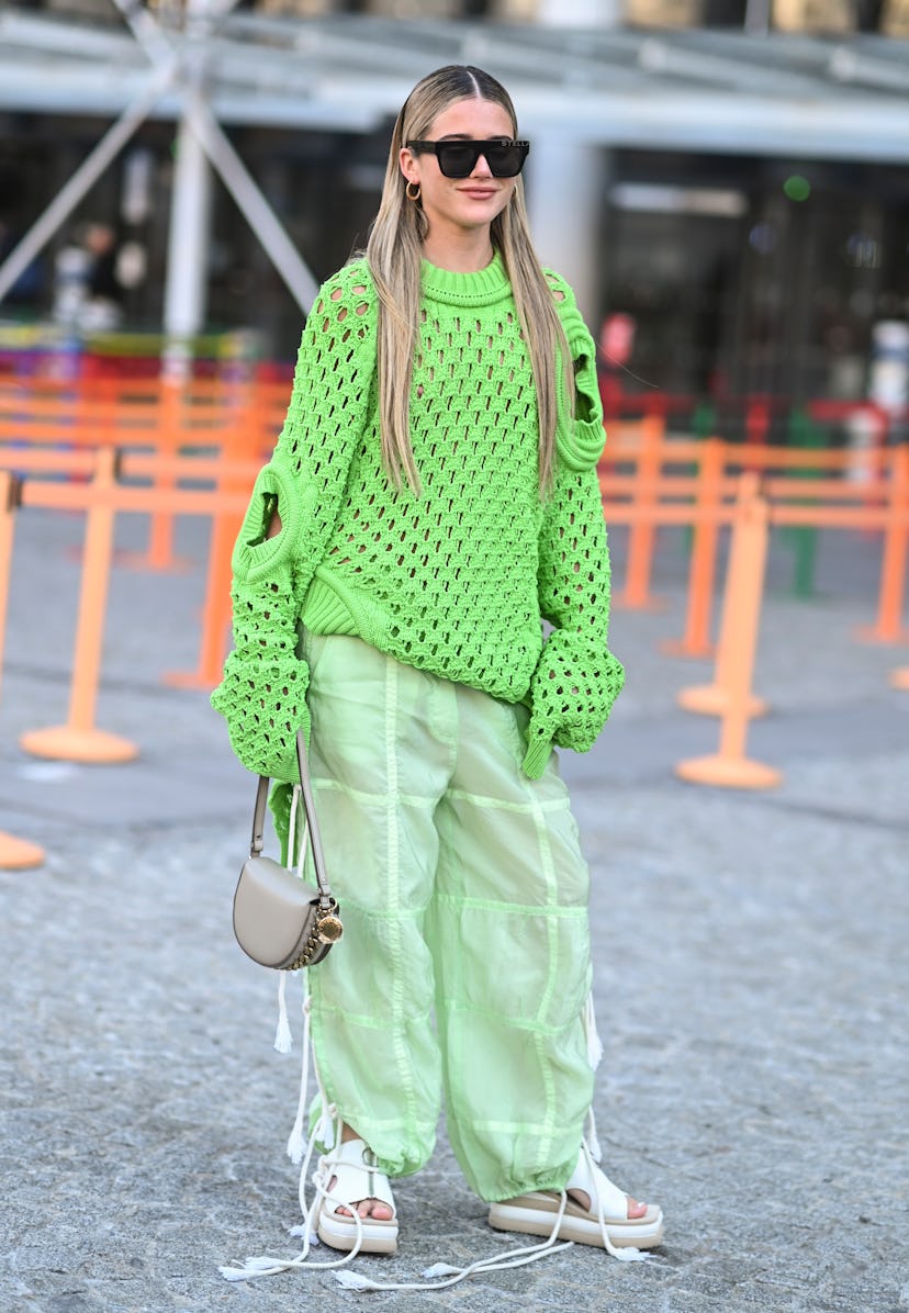 PARIS, FRANCE - MARCH 07: A guest is seen wearing a Stella McCartney lime green sweater and sheer pa...