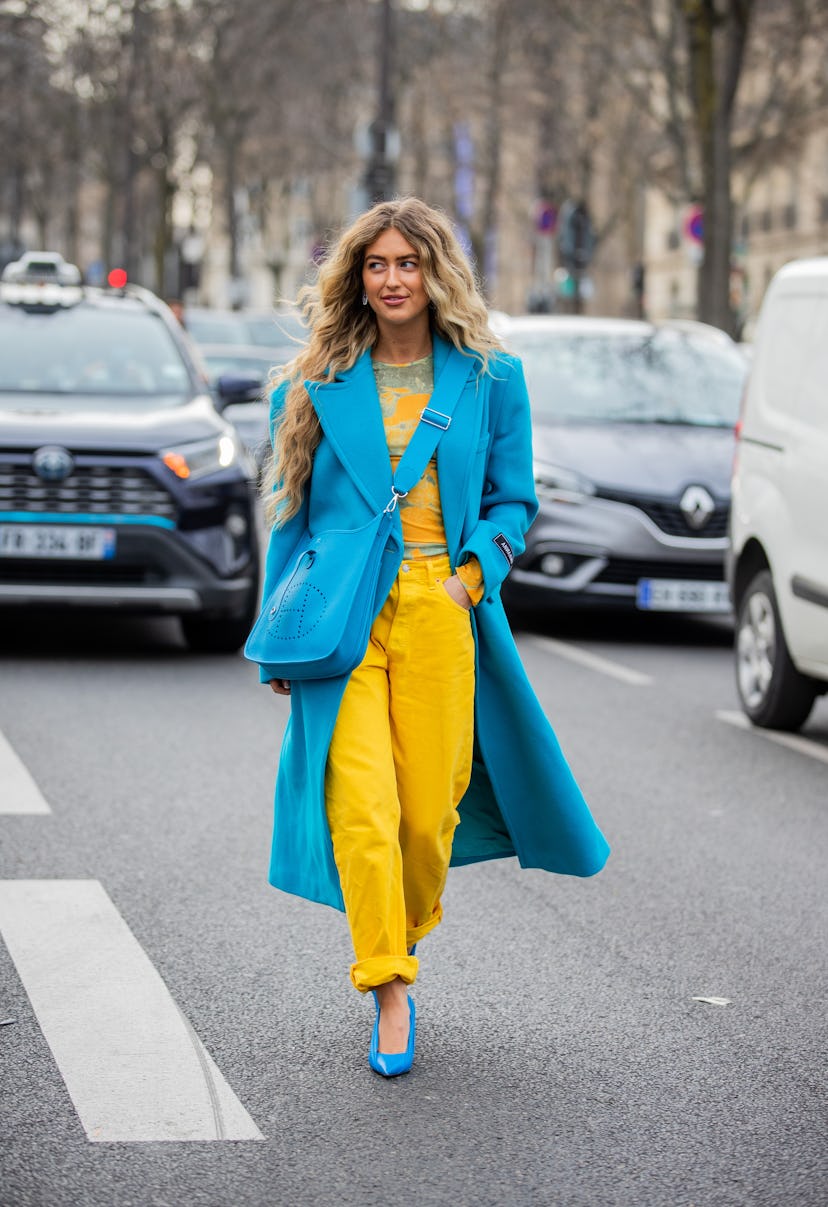 PARIS, FRANCE - MARCH 02: Emili Sindlev wearing blue coat, Hermes bag, yellow pants, blue heels Ukra...