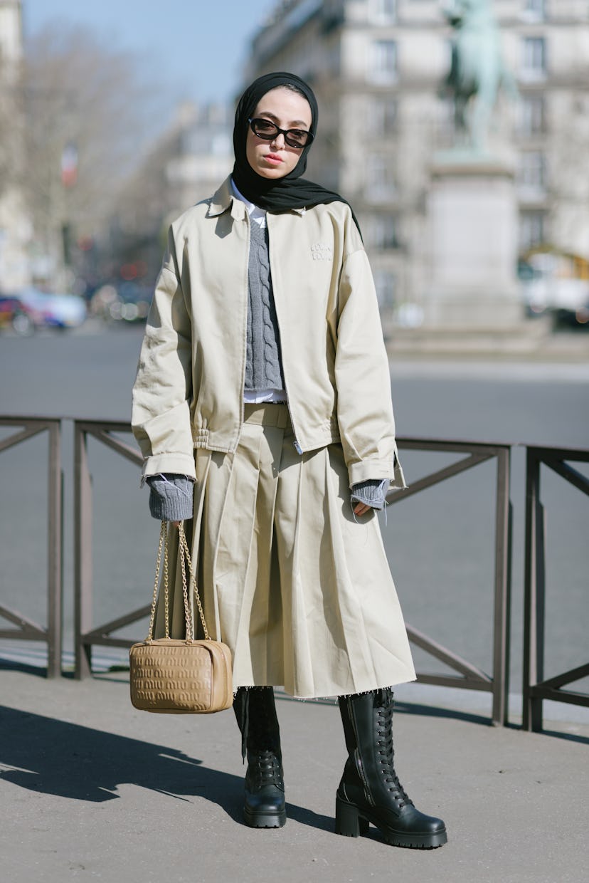 PARIS, FRANCE - MARCH 08: Lena Al Ghanti poses wearing a Miu Miu oversized chino beige jacket, a Miu...