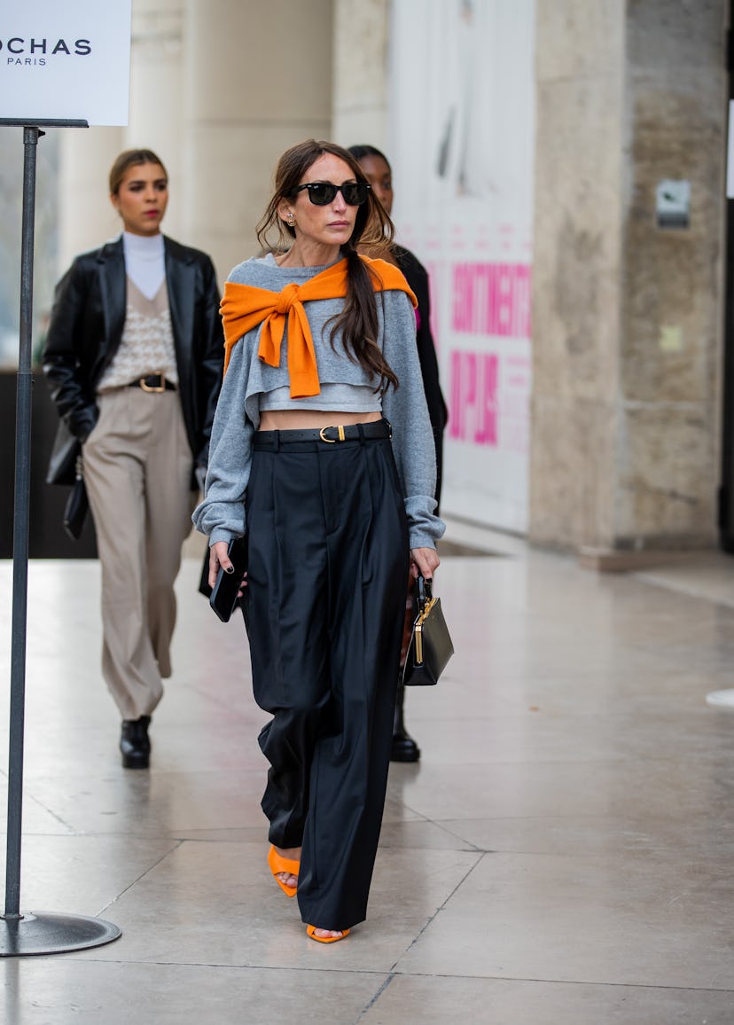 PARIS, FRANCE - MARCH 02: Chloe Harrouche seen wearing grey jumper, black belted pants, Jil Sander b...