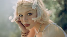Young woman resting beside a pond of water, knowing the week of March 14, 2022 will be the worst for...