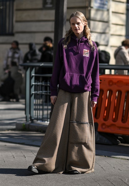 PARIS, FRANCE - MARCH 07: Hanne Gaby Odiele is seen wearing a purple Supreme hoodie and gold square ...