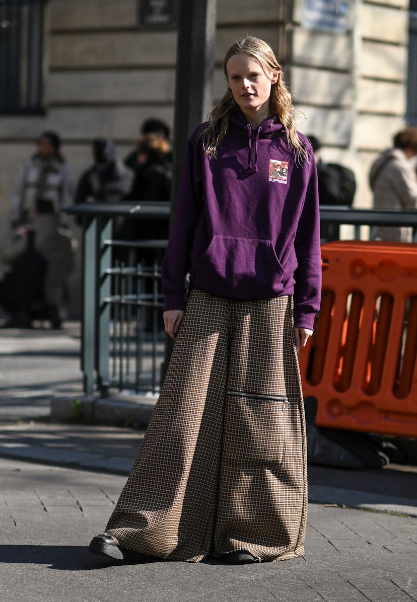 PARIS, FRANCE - MARCH 07: Hanne Gaby Odiele is seen wearing a purple Supreme hoodie and gold square ...