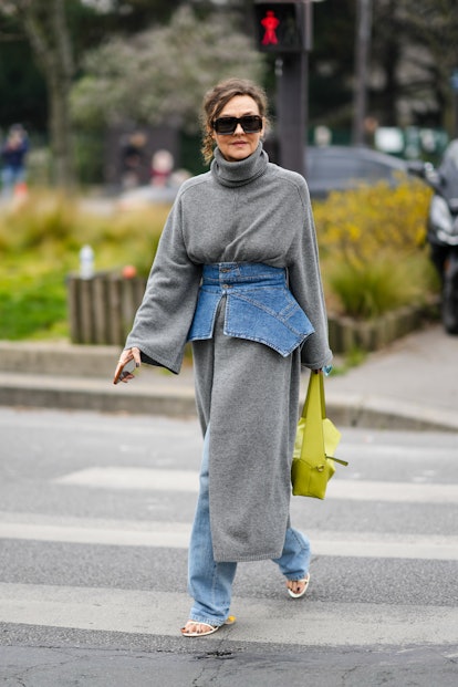 PARIS, FRANCE - MARCH 04: Renata Razdzyk wears black sunglasses, a gray wool turtleneck / long slit ...