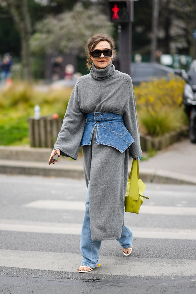 PARIS, FRANCE - MARCH 04: Renata Razdzyk wears black sunglasses, a gray wool turtleneck / long slit ...