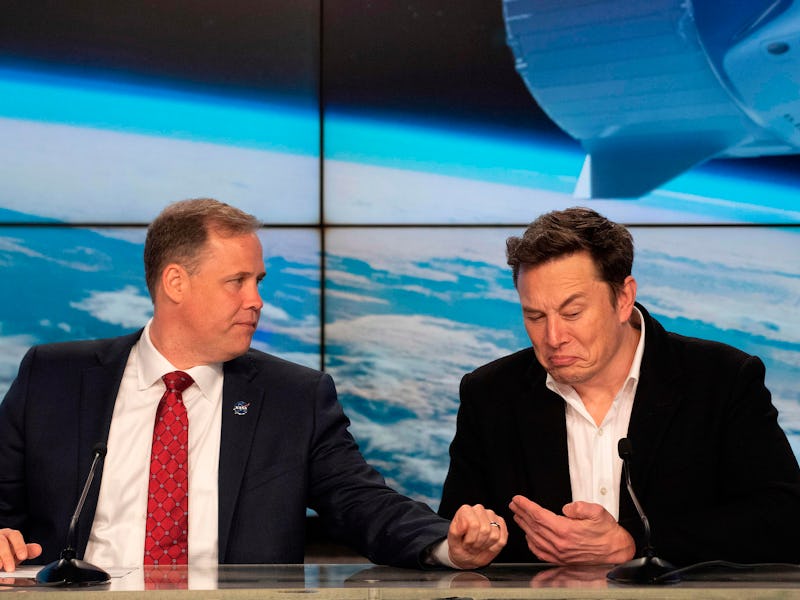 NASA Administrator Jim Bridenstine (L) speaks with SpaceX chief Elon Musk during a press conference ...
