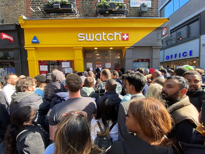 Customers congregate at the doors to the closed Swatch store on Carnaby Street, central London, afte...