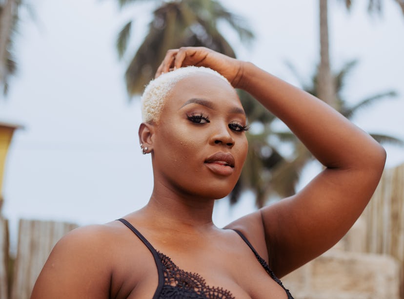 Young woman with bleach blonde hair, thinking about the April 2022 full Pink Moon on April 16, which...