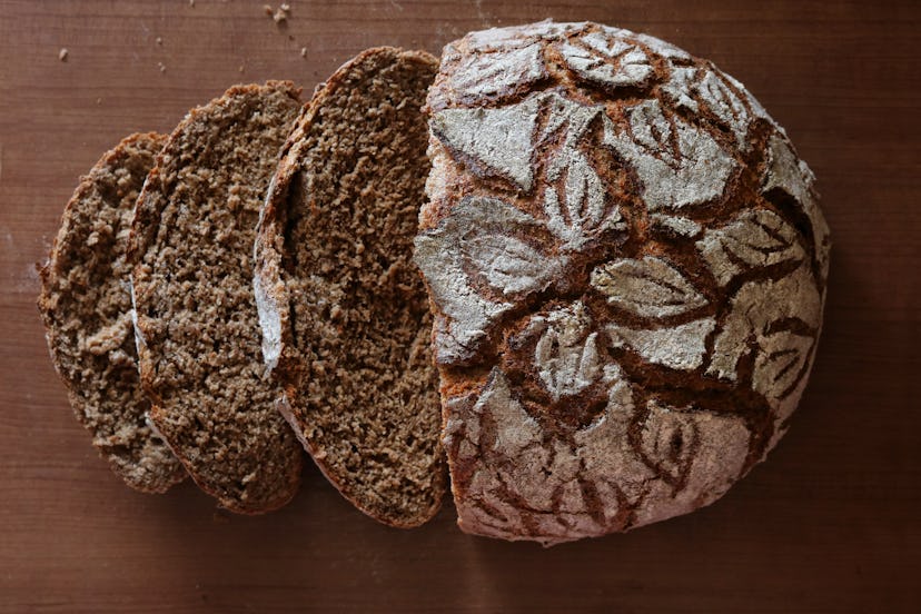 Whole grains such as in this rustic rye bread loaf with fancy floral pattern scoring atop are a grea...