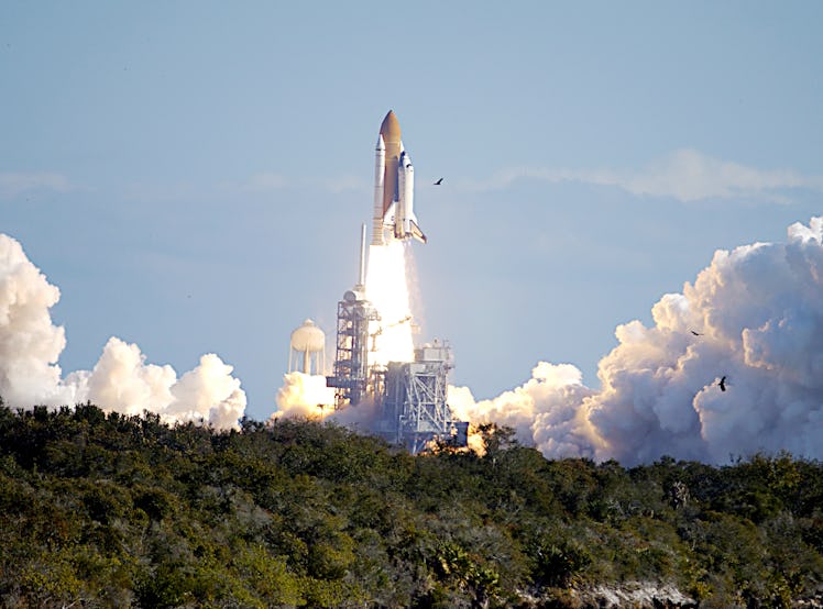 Through a cloud-washed blue sky above Launch Pad 39A, Space Shuttle Columbia hurtles toward space on...