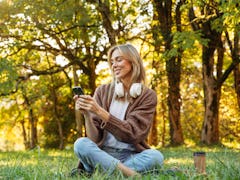 A woman thinks of Earth Day captions and quotes to use for her nature Instagram and TikTok posts.