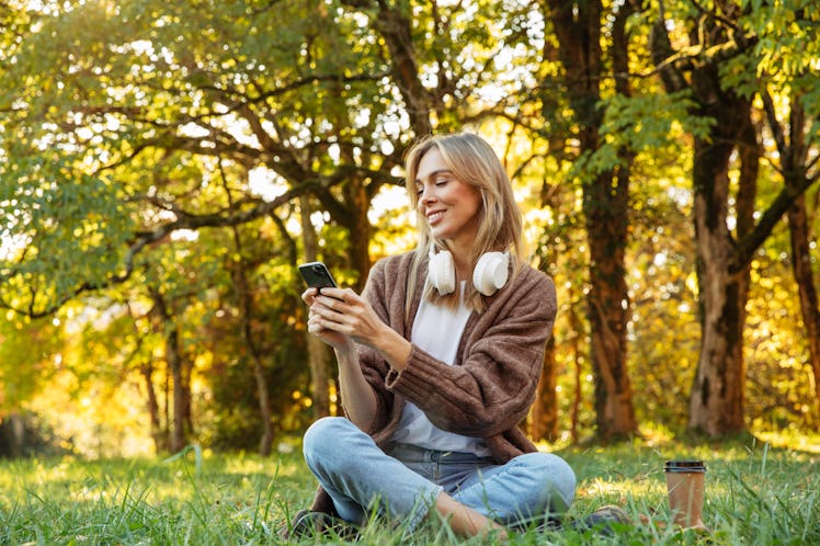 A woman thinks of Earth Day captions and quotes to use for her nature Instagram and TikTok posts.