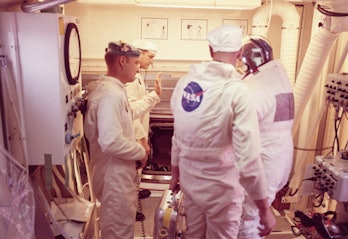One of the three Apollo 13 astronauts prepares to enter the spacecraft in the white room 320 feet ab...