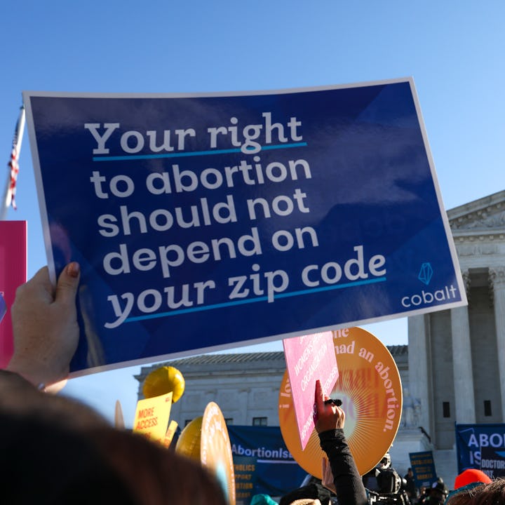 Abortion rights advocates demonstrate in front of the Supreme Court. Oklahoma Governor Kevin Stitt j...