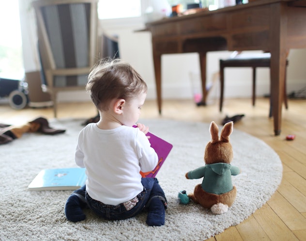 baby girl sitting with bunny doll in a round up of vintage baby names