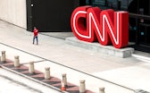 ATLANTA, GEORGIA - MARCH 15: People walk by the world headquarters for CNN on March 15, 2022 in Atla...