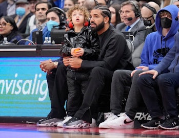 TORONTO, ON - APRIL 7: Drake sits with his son Adonis while the Toronto Raptors play the Philadelphi...