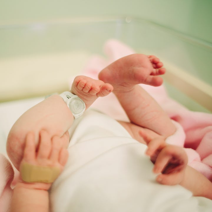 View of baby's feet with a hospital security tag on - which this TikTok mom doesn't feel is enough t...