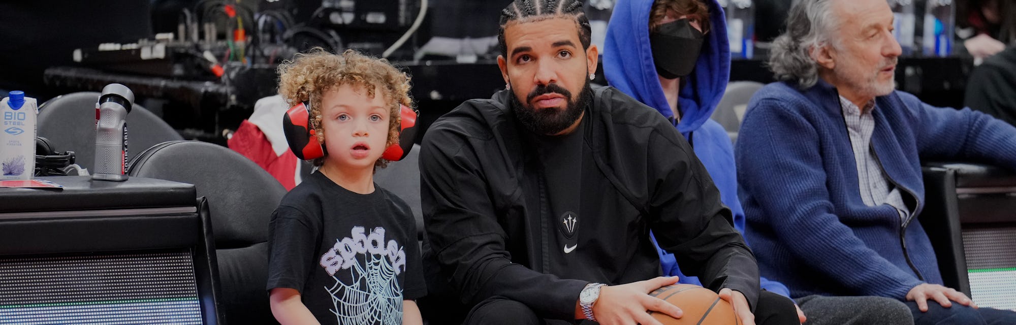 TORONTO, ON - APRIL 7: Drake sits with his son Adonis before the Toronto Raptors play the Philadelph...