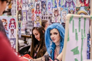 TORONTO, ONTARIO, CANADA - 2017/03/17: A vendor with blue hair waits for customers at her booth, sel...