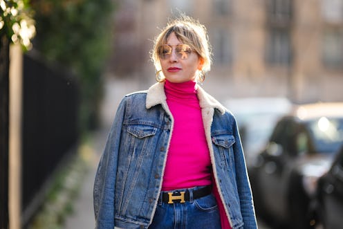 PARIS, FRANCE - MARCH 19: Emy Venturini wears sunglasses from Prada, gold earrings, a neon pink tutl...