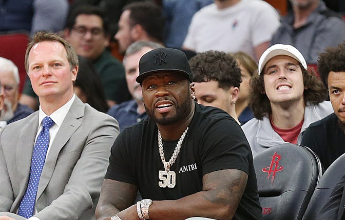 HOUSTON, TEXAS - MARCH 16: American rapper, actor and entrepreneur 50 Cent sits court-side as the Ph...