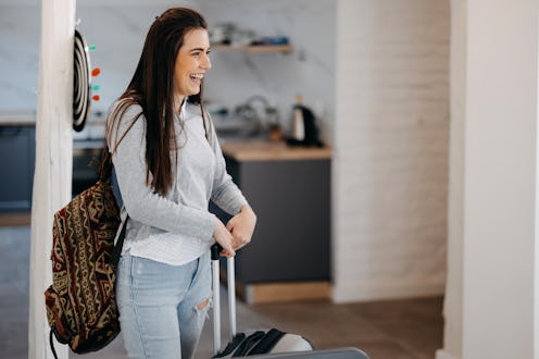 Portrait of excited emotional woman walking in her apartment, entering new home. Woman enters a rent...