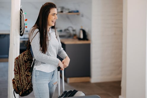 Portrait of excited emotional woman walking in her apartment, entering new home. Woman enters a rent...