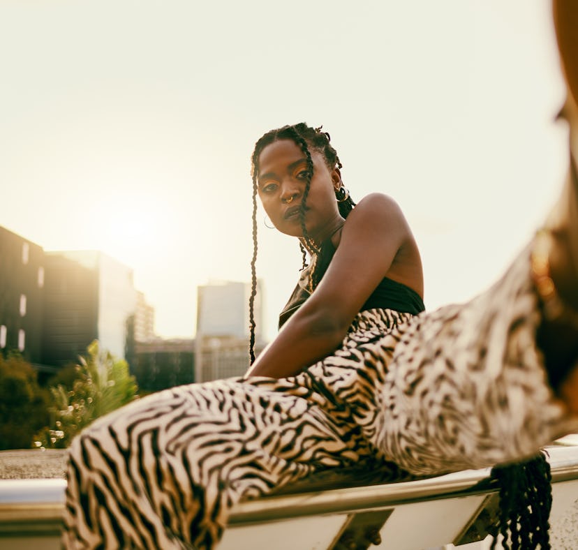young woman kicks foot towards camera as she thinks about the 2022 mars-jupiter conjunction in aries
