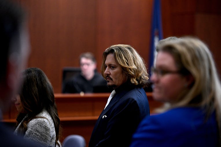 US actor Johnny Depp (C) is seen during the $50 million Depp vs Heard defamation trial at the Fairfa...