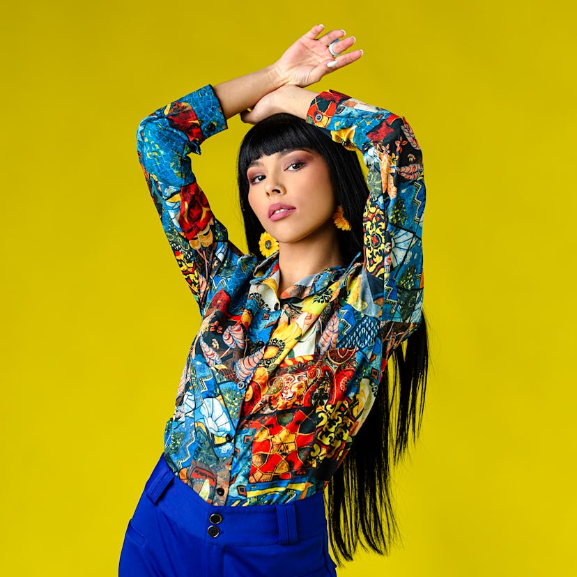 Young woman posing a retro style shirt, knowing her lucky zodiac sign will have the best month of Ma...
