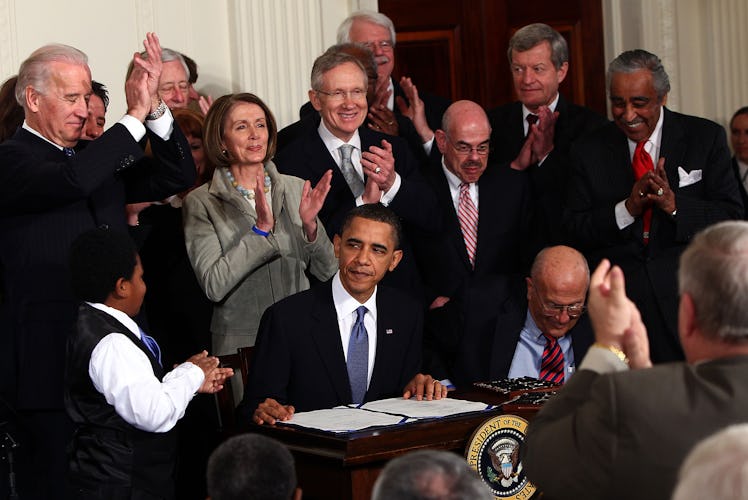 WASHINGTON - MARCH 23:  U.S. President Barack Obama (C) is applauded after signing the Affordable He...