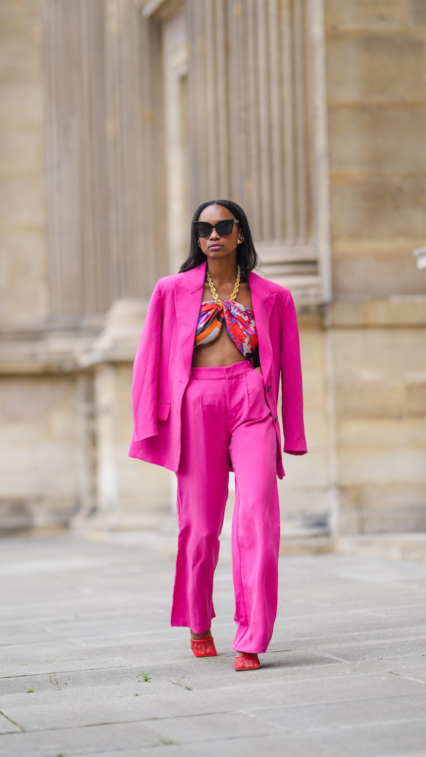 Emilie Joseph wears a hot pink suit outfit.