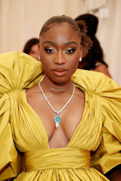 Normani with a brown and gold, cut crease makeup look at The 2021 Met Gala.
