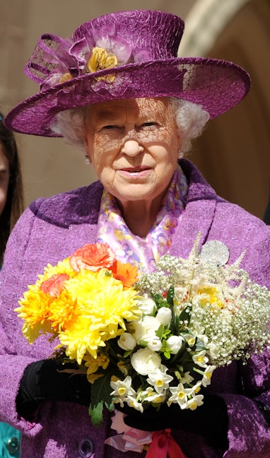 Britain's Queen Elizabeth II holds flowers as she leaves an Easter Sunday church service in Windsor ...