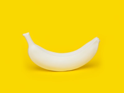 A banana standing in front of a yellow background representing the morning penile erection