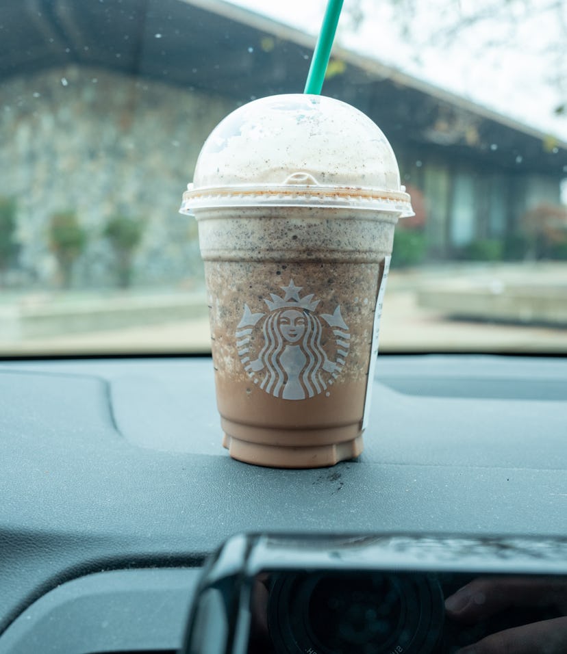 Starbucks Frappuccino beverage on the dashboard of a vehicle, Moraga, California, December 4, 2021. ...