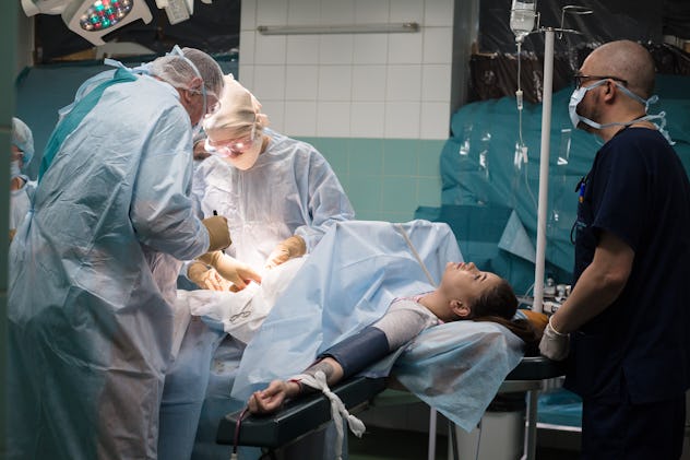 woman getting a c-section in a hospital room